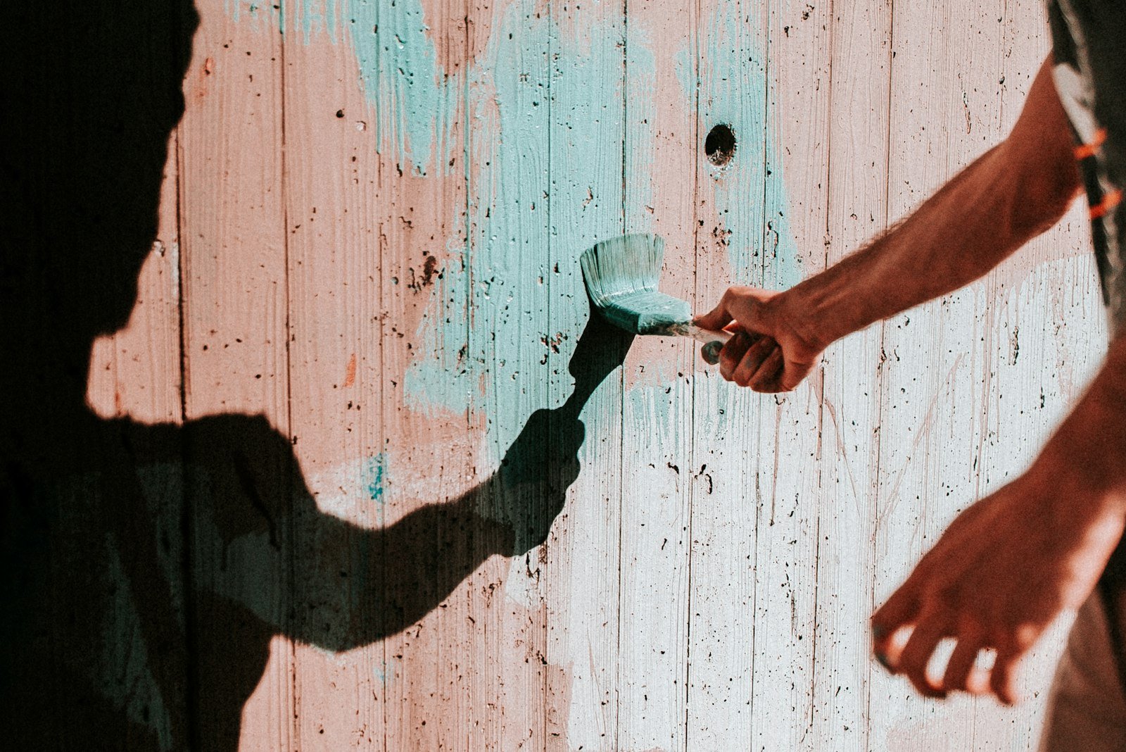 Professional painter applying paint to an interior wall
